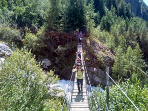 Hikers on TMB suspension bridge