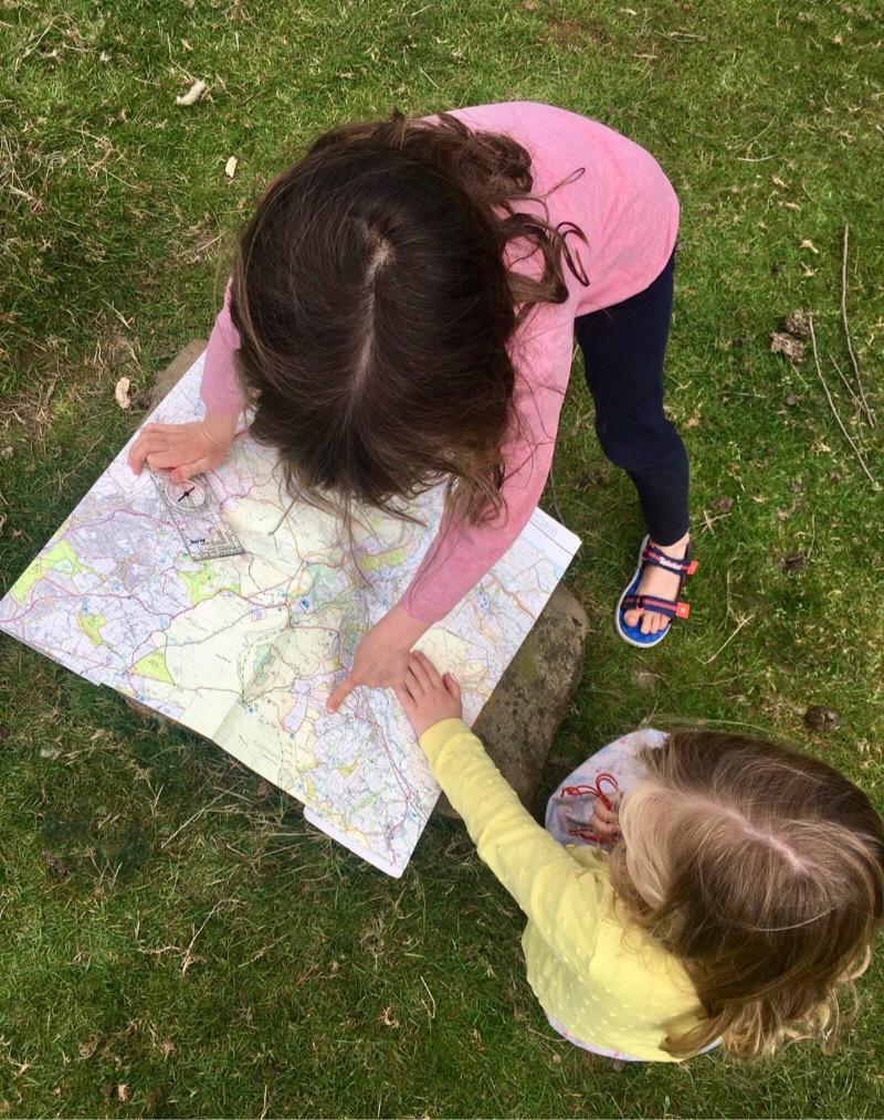 Two young children looking at a map