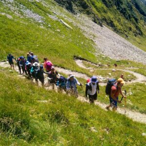 Group of people hiking up to the Col de Tricot