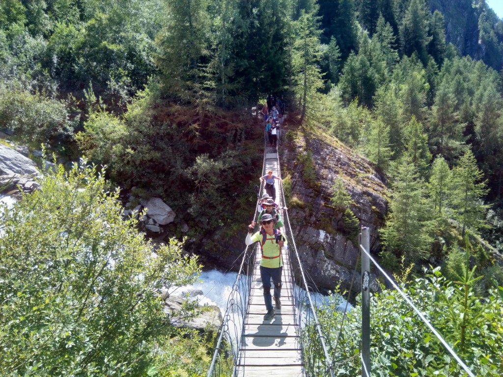 Hikers on a narrow suspension bridge