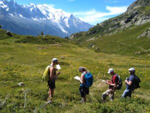 Hikers with maps in front of Mont Blanc