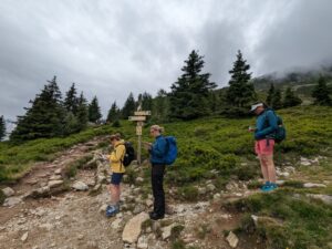 Three navigators on a cloudy day in the mountains