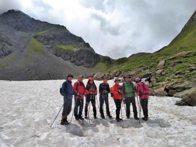 Group of hikers on summer snow