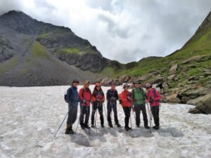 Hikers on snow on the One Week Tour du Mont Blanc