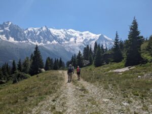 Hikers on track in front of Mont Blanc