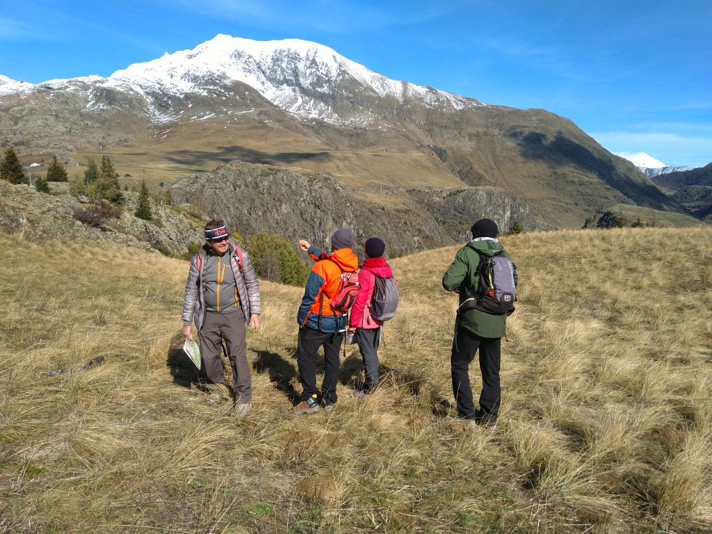 Four hikers in front of a mountain