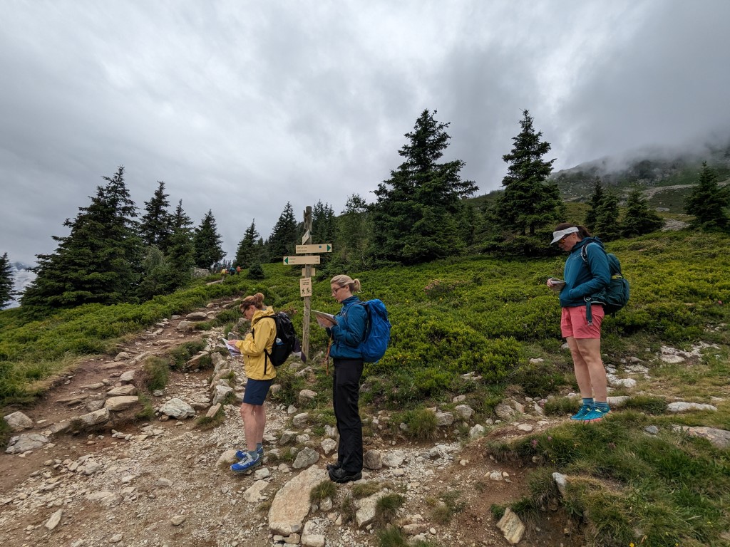 Three hikers practising navigation skills