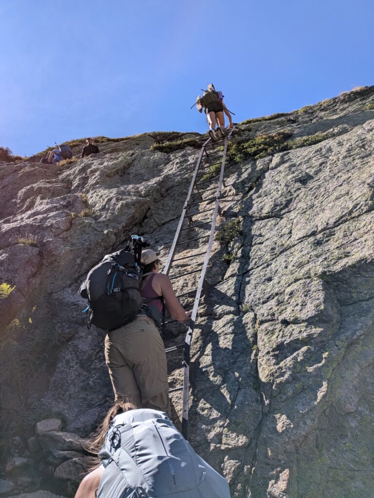 Prepare for the difficulties - hikers on a ladder